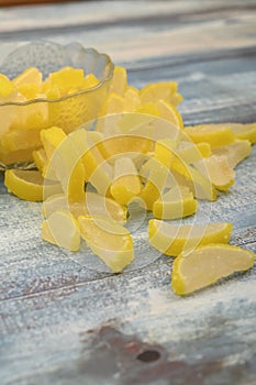 Marmalade lemon slices on wooden background. Sweet dessert. Close up