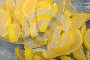 Marmalade lemon slices on wooden background. Sweet dessert. Close up