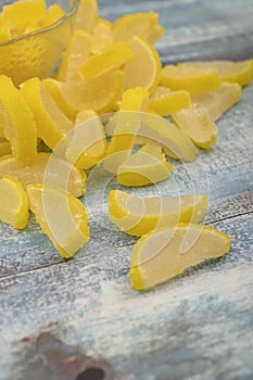 Marmalade lemon slices on wooden background. Sweet dessert. Close up