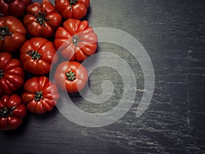 Marmande tomatoes on slate background