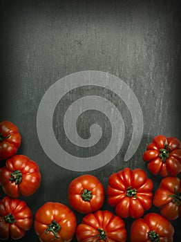 Marmande tomatoes on slate background