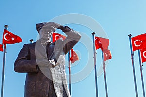 MARMARIS, TURKEY - SEPTEMBER 19, 2017:A top of Mustafa Kemal Ataturk Monument in Marmaris flanked Turkish flags under blue sky