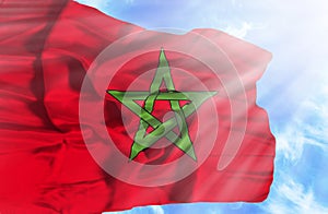 Marocco waving flag against blue sky with sunrays