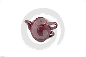 Maroon ceramic teapot on white background