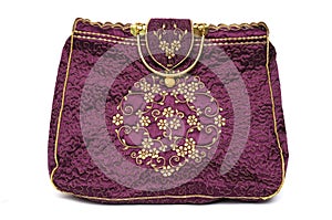 A maroon red colored ladies hand carry handbag