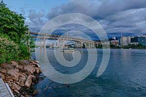 Marquam Bridge over Willamette River with boats in Portland, USA