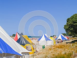 Marquees and people erected at beach event