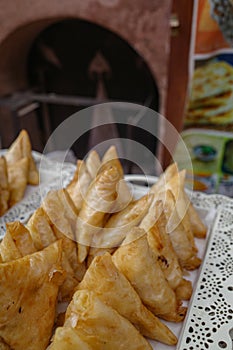 Marrakech, Morocco - Feb 10, 2023: Moroccan fried samosas, a popular street snack, on sale in the Medina market