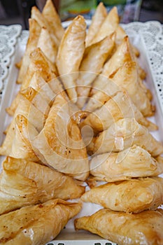 Marrakech, Morocco - Feb 10, 2023: Moroccan fried samosas, a popular street snack, on sale in the Medina market