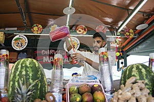 Marrakesh, Morocco - Oct 17, 2022: Marrakesh juice and smoothie seller making one with delicious fresh fruit in Jemaa el Fna