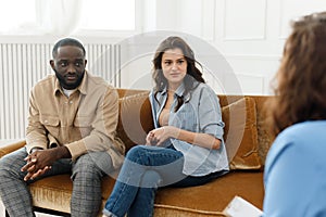 Marriage consulting. Spouses talk to a family psychologist during a meeting after a quarrel, sitting in the office