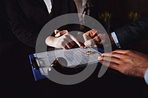 Marriage contract sign concept. Man and woman signing documents.