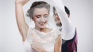 Marriage, couple and dancing for happy in studio, celebration and care by wedding party on white background. Man, woman