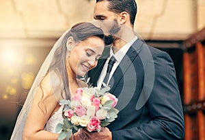 Marriage love, flower bouquet and wedding couple kiss after partnership commitment, floral trust ceremony and unity