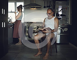 Marriage, problem and mental health issue with bored old couple in toxic, dark or sad family home kitchen together