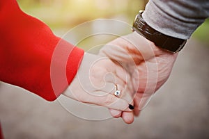 Marriage proposal. Man hold engagement ring at red box in his ha