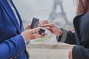 Marriage proposal in Paris, wedding in France, hands with engagement ring
