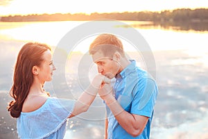 Marriage proposal on sunset . young man makes a proposal of betrothal to his girlfriend on the beach