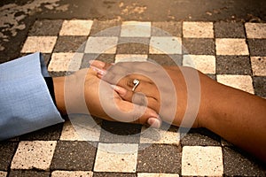 Marriage proposal, wedding ring. Latin couple holding hands.