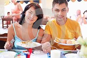 Married couple having breakfast at restaurant