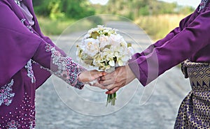 Married couple holding hand.