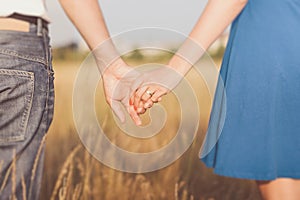 Married couple holding hands at sunset