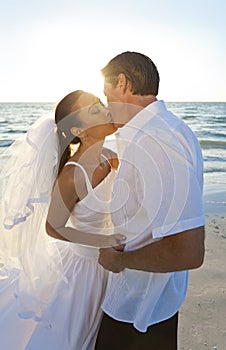 Married Couple Kissing at Sunset Beach Wedding