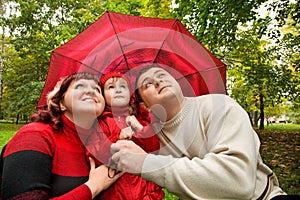 Married couple and little girl with umbrella