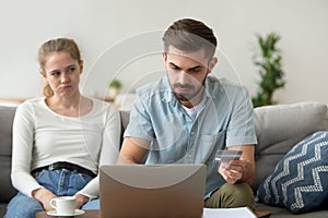 Married couple making payments online with credit card using lap