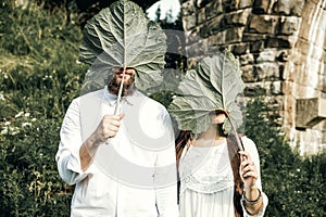 Married Couple near the old bridge with burdoks