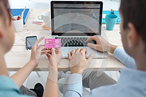 Married couple shopping online at home