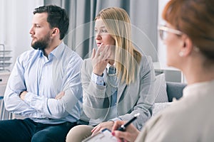 Married couple showing ignorance during a therapy session with a psychologist photo