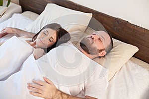 Married couple sleeping in the bedroom