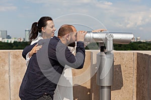 Married couple spending relationship anniversary on building rooftop