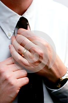 Married Hands Straighten a Necktie photo