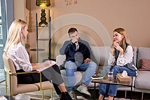 caucasian couple talking to marriage counselor before breaking up, consulting family relationships expert,in office