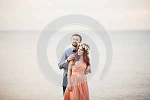 Married wedding couple standing on a wharf over the sea