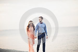 Married wedding couple standing on a wharf over the sea