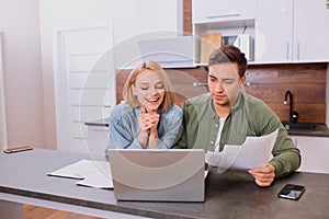 Married young couple enjoy working together at home