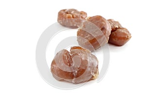 Marron glaces on white background. They are a confections made of chestnut candied in sugar syrup and glazed. photo