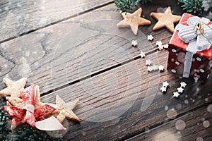 Marry Christmas. New Year background with fir branches and Christmas shortbread cookies stars with red ribbon, fir tree on right