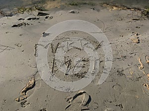 Marry me message written on sand closeup view with selective focus on foreground