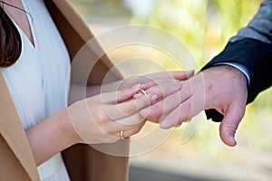 Marry me today and every day, hands of a wedding heterosexual couple. The bride put the ring on her husband's finger. Soft