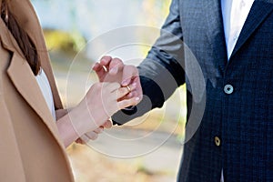 Marry me today and every day, hands of a wedding heterosexual couple. The groom put the ring on the finger of his beautiful wife.