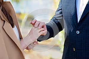 Marry me today and every day, hands of a wedding heterosexual couple. The groom put the ring on the finger of his beautiful wife.