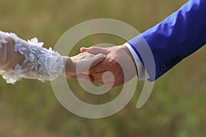 Marry me today and everyday. Newlywed couple holding hands, wedding picture.