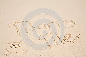 Marry me written on sand photo