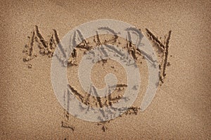 'Marry Me' Written in Sand on Beach