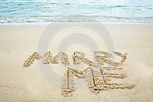 Marry Me Written On Sand Near The Coast