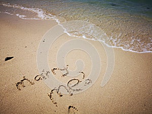 Marry Me written on sandy beach and beautiful sunny day with blue sky